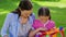 Young girl being given a kite by her mother