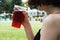 Young girl in bikini with red lemonade in hand with defocused sw