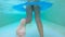 Young Girl in Bikini Swimsuit Swimming in Pool on Rubber Ring. Underwater Slowmotion Footage. Thailand.