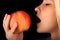 Young girl biting big Apple, woman eats apple, healthy eating