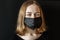 Young girl in a black protective three-layer facial surgical mask. The concept of life in the coronavirus pandemic and after. The