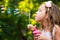 Young girl blowing bubbles.