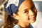 A young girl in blue bandanna