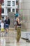 A young girl with blue hair juggles with rubber balls