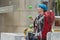 A young girl with blue hair juggles with rubber balls