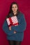 Young girl in a blue sweater squeezes a christmas gift