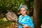 Young Girl In Blue Tie Dye and Bandana Holds the Rotting Shell o