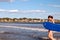 A young girl boogie boards in the low surf