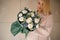 Young girl with bouquet in dark green wrapping