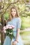 Young girl with a bouquet of peonies in the park, garden. Summer, spring