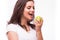 Young girl with brances eat apple. Female teeth with dental braces and apple.