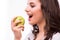 Young girl with brances eat apple. Female teeth with dental braces and apple.