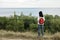 Young girl (brunette) and jeans with a red backpack looking out