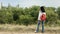 Young girl (brunette) and jeans with a red backpack looking out