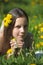 The young girl the brunette lies on a glade with dandelions