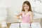 Young Girl Brushing Teeth at Sink