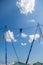 Young girl bungee jump high up in the air with blue sky and clouds.