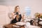 Young girl in the cabin of a business class airplane with a phone in her hands comfortable luxury travel