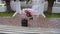 A young girl carries the luggage up the stairs