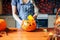 Young girl carving a pumpkin at Halloween