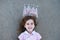 Young girl with chalk drawn crown