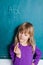 Young girl and chalkboard with letters