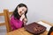 young girl with changing teeth is working on a large pork rib