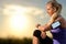 Young girl checking workout on smart watch at sunset.