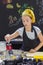 Young girl in a chef`s hat cooks in a large saucepan in a black