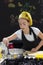 Young girl in a chef`s hat cooks in a large saucepan in a black