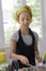 Young girl in a chef`s hat cooks in a large saucepan in a black