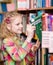 Young girl chooses a book in the library