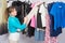 Young girl chooses clothes in wardrobe, and looked into the frame