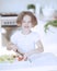 Young girl chopping tomatoes and making a salad in the kitchen