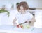 Young girl chopping tomatoes and making a salad in the kitchen