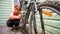 Young Girl Cleaning Her Bicycle With Brush And