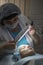 A young girl is cleaning the skin of her face at a cosmetologist. Facial cleansing and massage