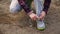 Young girl commits an outdoor walk and stopped to tie his shoelaces on sneakers