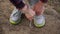 Young girl commits an outdoor walk and stopped to tie his shoelaces on sneakers