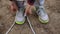 Young girl commits an outdoor walk and stopped to tie his shoelaces on sneakers