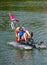 A young girl commutes to her destination on her boat