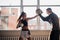 A young girl conducts kickboxing training and practices paw strikes with a professional boxer