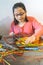 A young girl is constructing with lots of colorful plastic sticks. fun with building geometric figures and learning mathematics at