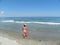 Young girl contemplating the mesmerizing ocean waves