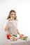 young girl cook bites cucumber prepares cut vegetable or salad healthy food concept vegetarian food beauty and youth