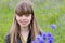 Young girl in cornflower field