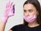 Young girl cosmetologist and brow specialist in a mask and protective gloves,