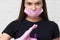 Young girl cosmetologist and brow specialist in a mask and protective gloves,