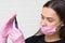 Young girl cosmetologist and brow specialist in a mask and protective gloves,