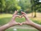 Young girl couple making heart shape with hands, love and relationships concept